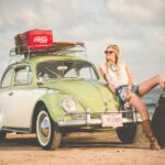 woman leaning on a car thinking what countries to visit next