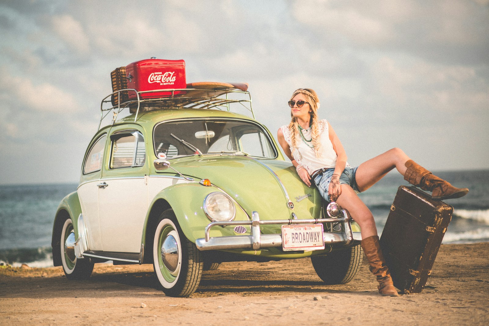 woman leaning on a car thinking what countries to visit next