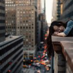 woman leaning on top building in one of the safest city